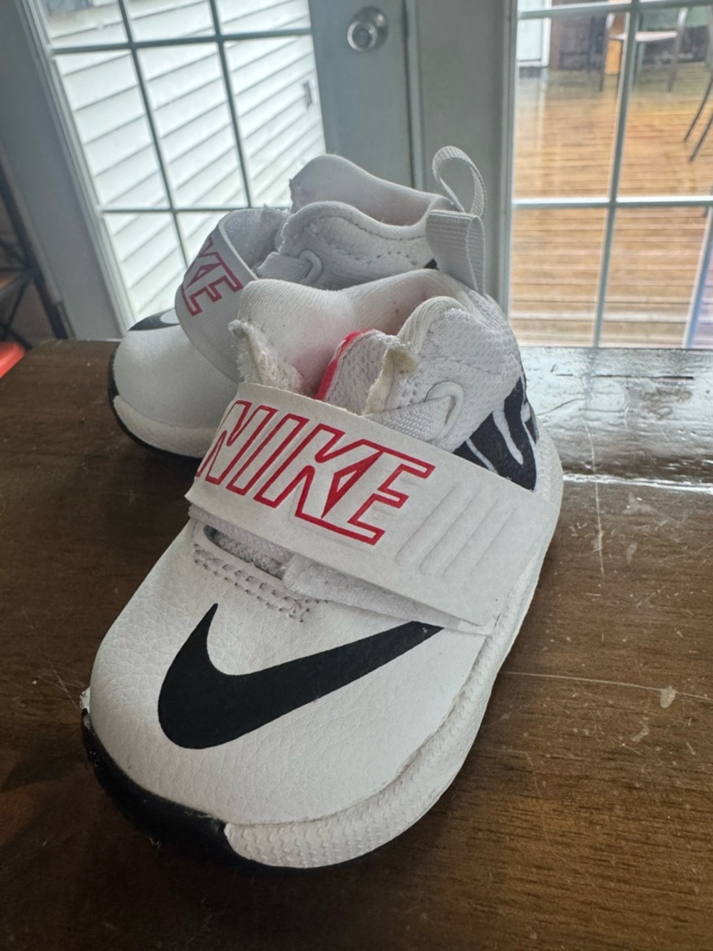 Nike White Infant Sneaker with Black Swoosh and Red Logo Size 2C